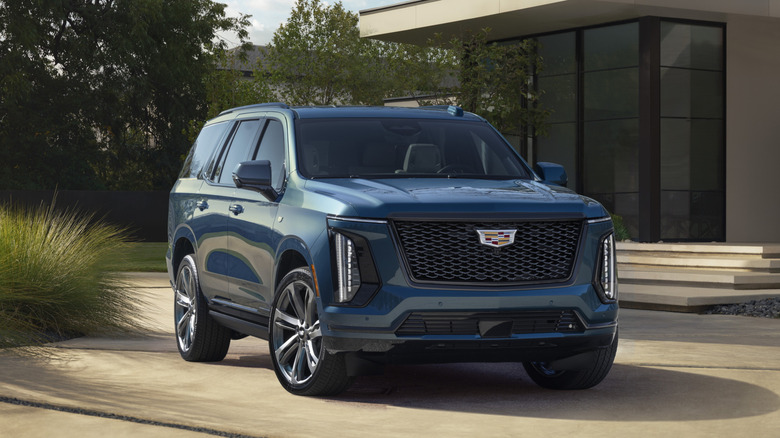 Blue 2025 Cadillac Escalade parked in front of building