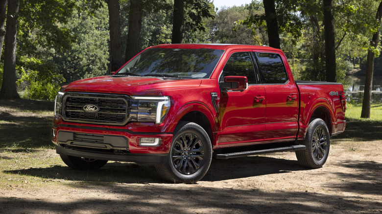 Red 2024 Ford F-150 Lariat parked on dirt