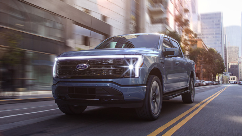 Blue 2022 Ford F-150 Lightning in motion