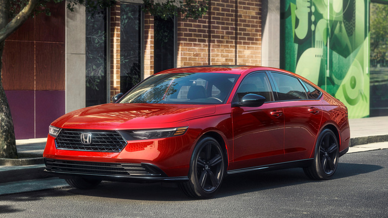 Orange 2023 Honda Accord parked on sidewalk