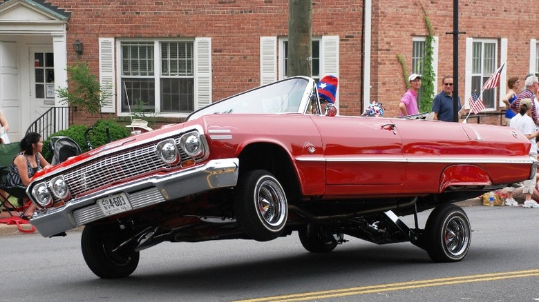 Red 1963 Chevrolet Impala Convertible on 3 wheels