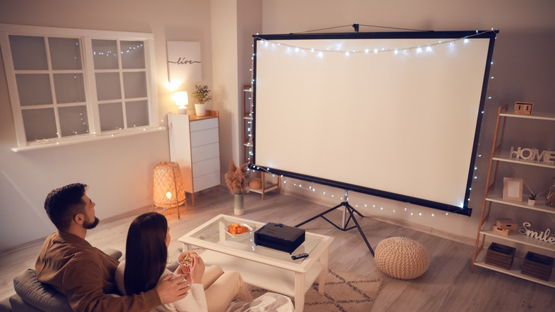 couple watching TV on big screen