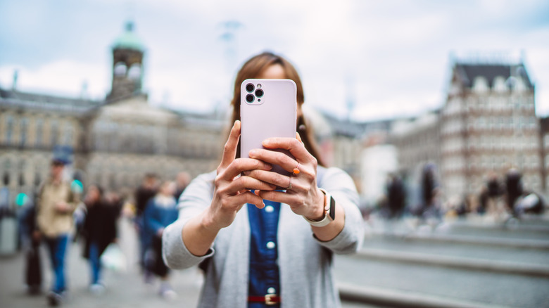 Woman taking picture with phone