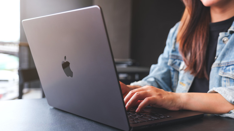 Woman typing at MacBook