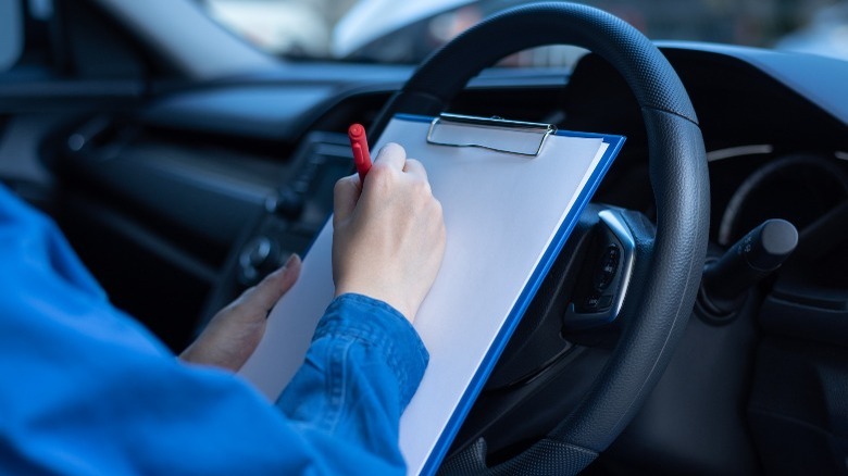 man making notes of his inspection