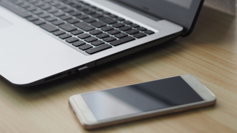 Phone sitting next to laptop