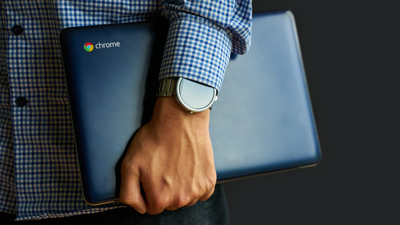 man holding chromebook