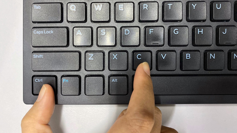 hand pressing keyboard shortcut