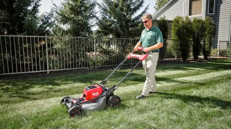 homeowner using Milwaukee mower