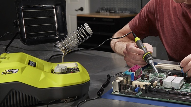 Man soldering with the One+ 18V 45W Hybrid Soldering Station