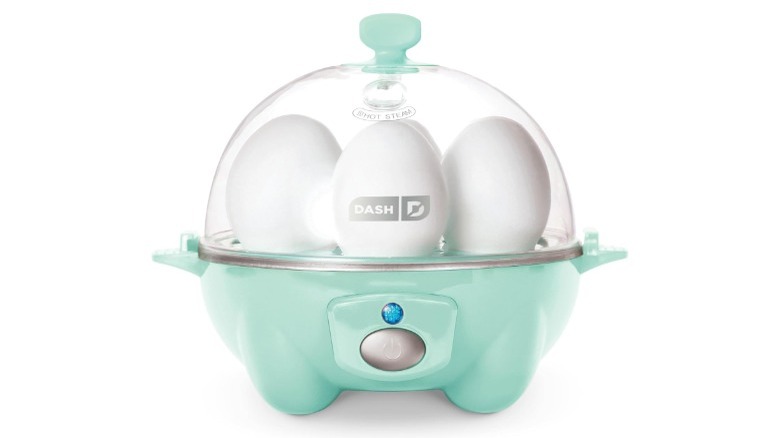 A Dash Rapid Egg Cooker holding four eggs