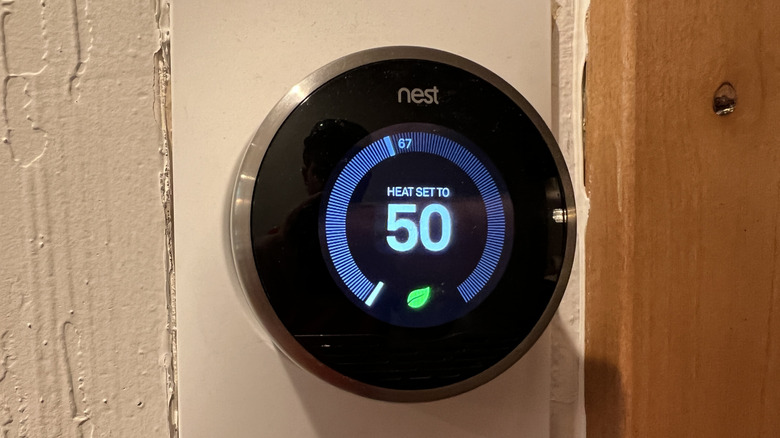 A Google Nest thermostat on a wall