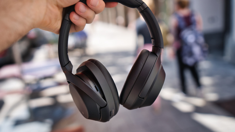 Sony xm4 headphones in a person's hand