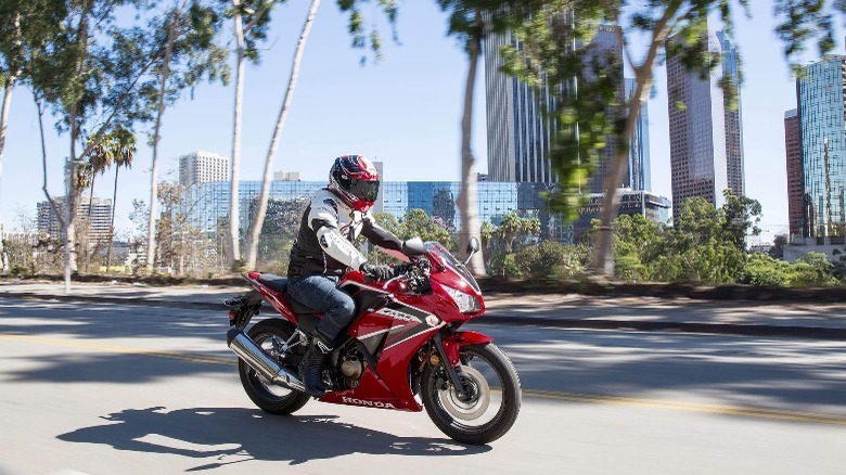 a man on a red Honda CBR300R