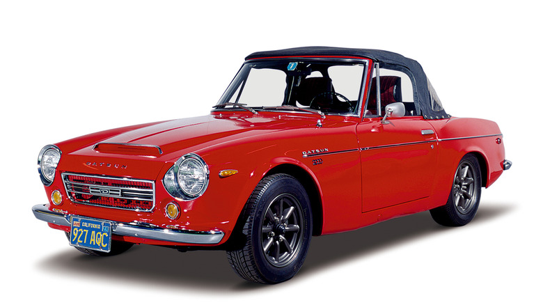 Red Datsun 2000 Sports Roadster on white background front 3/4 view