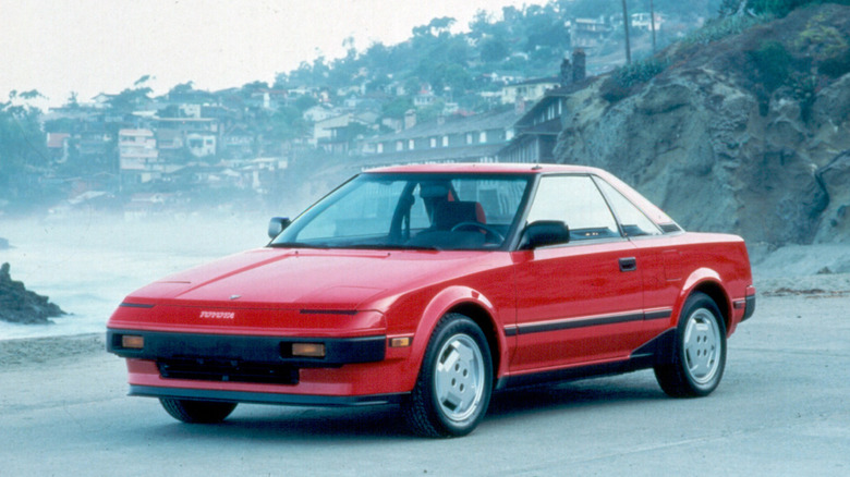 Red Toyota MR2 AW11 parked on a beach