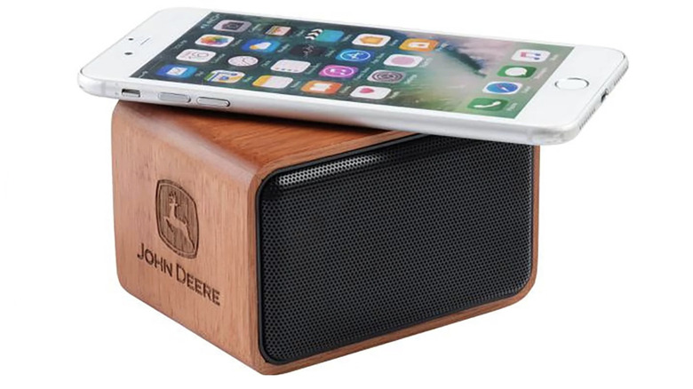 John Deere Wooden Wireless Bluetooth Speaker with smartphone on white background.