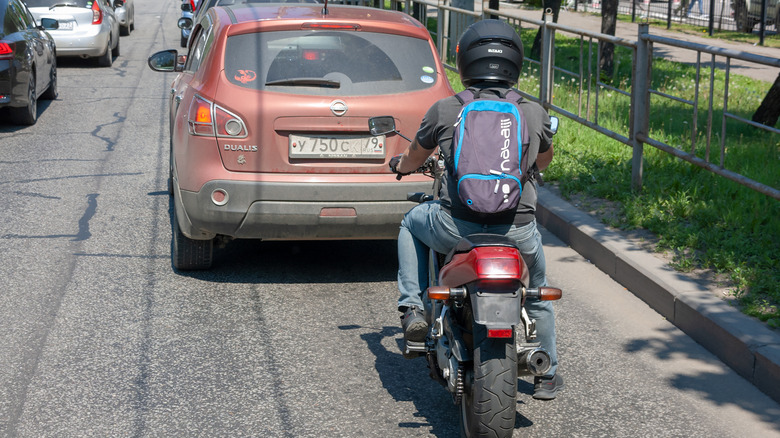 motorcyclist driving near the edge of a lane