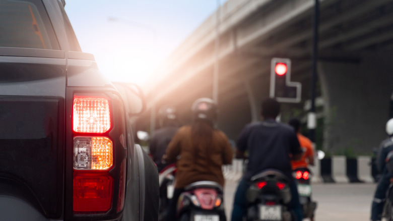 unfocused image of motorcyclists at red light