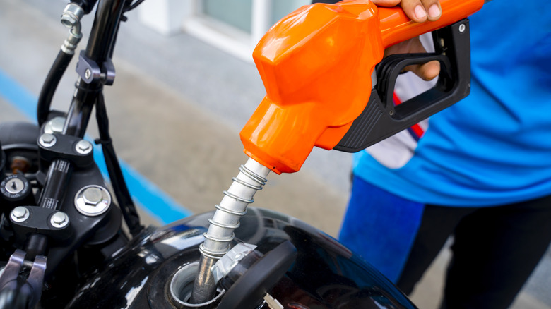 filling up motorcycle at the pump