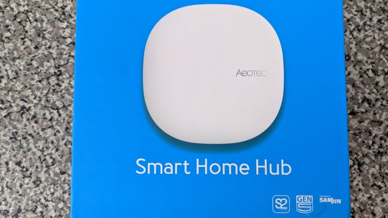 An Aeotec Smart Home Hub in its box on the floor