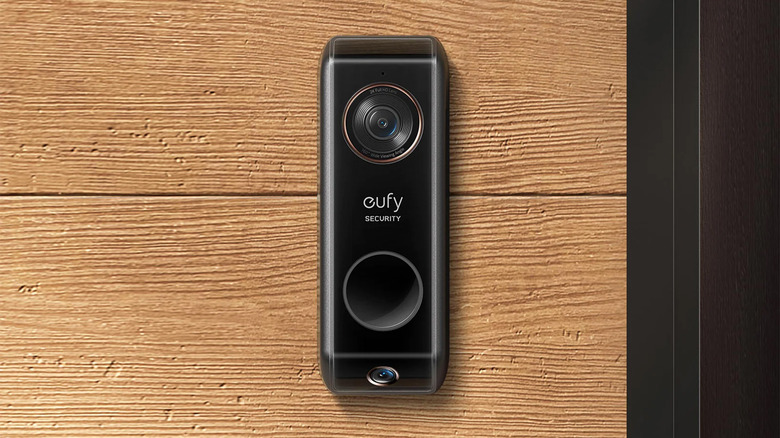 A EUFY S330 smart doorbell on a a wood house