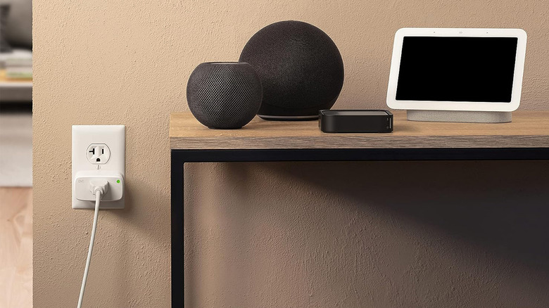 An Eve Energy smart plug with smart speakers on a table