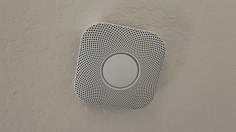 A Google Nest Protect mounted to a white ceiling