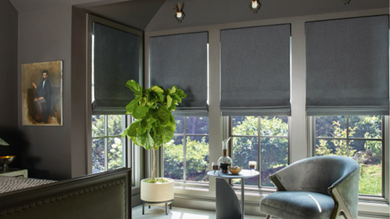 A well-lit room with dark gray smart blinds