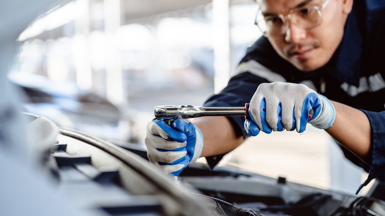 an auto mechanic working on car