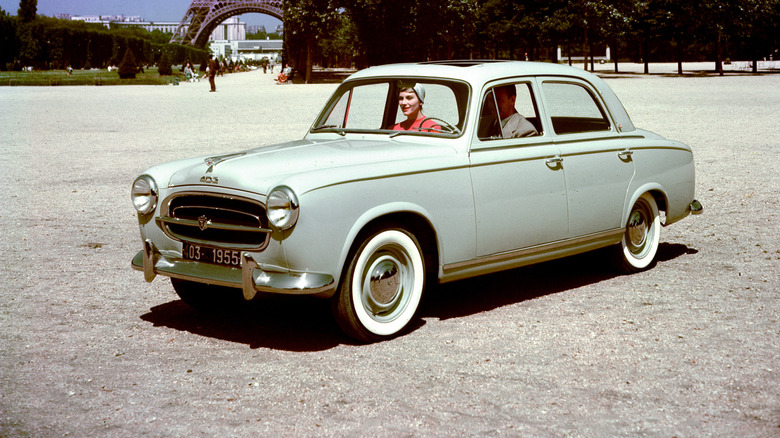 1958 Peugeot 403 saloon in Paris with the Eiffell tower peaking in the background