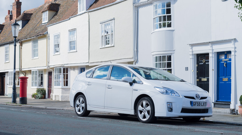 white Toyota Prius parked on a city street