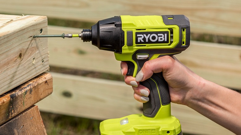 Man using Ryobi impact driver