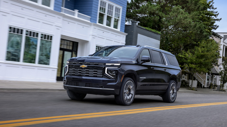 Chevrolet Suburban driving at speed in urban environment