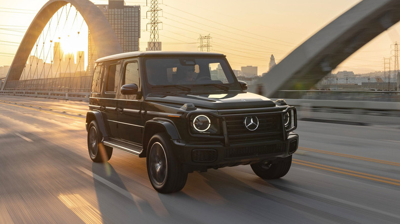 2025 Mercedes-Benz G550 driving at speed front 3/4 view