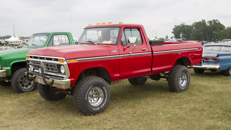 A red 1976 Ford F-150 with large tires