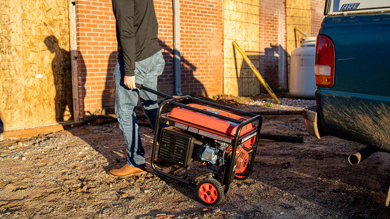 Person moving portable generator