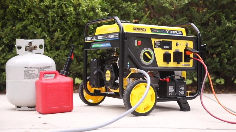 A portable generator with gas and propane tanks