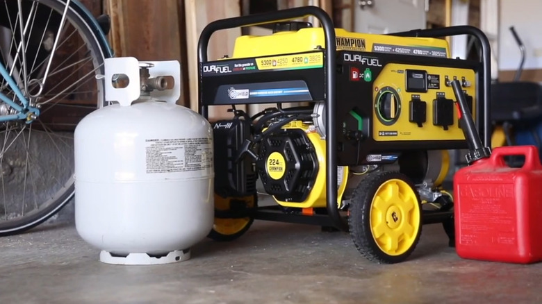 A portable generator with gas and propane tanks