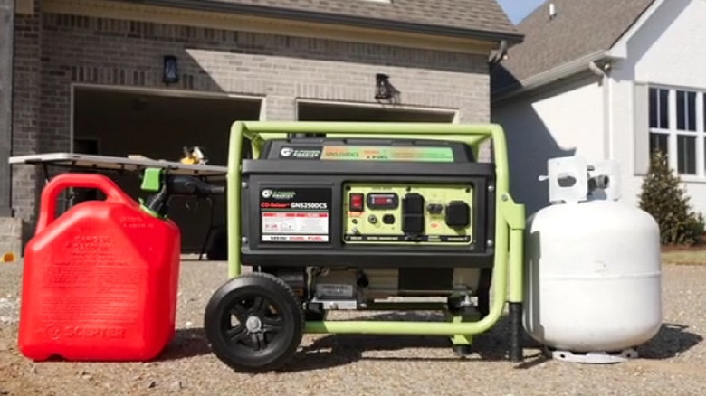 A portable generator with gas and propane tanks