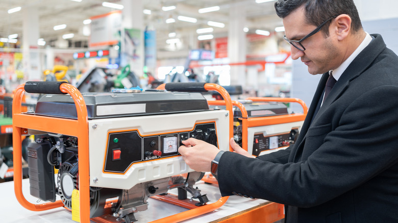 Person testing portable generator in store