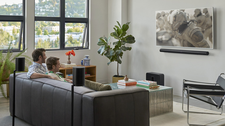 Men watching TV with a multi-channel soundbar setup