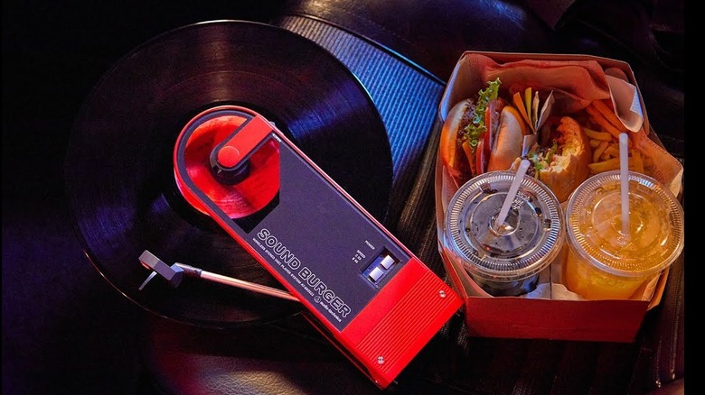 Audio-Technica Sound Burger record player with burgers and drinks beside it