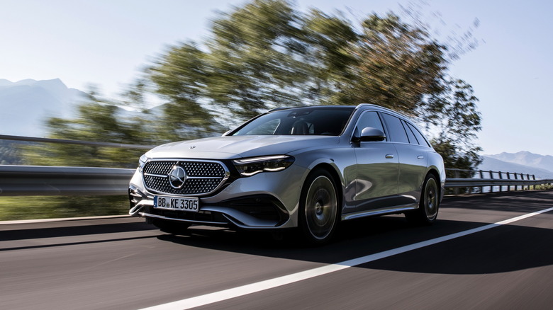 Silver metallic 2024 Mercedes-Benz E-Class driving at speed