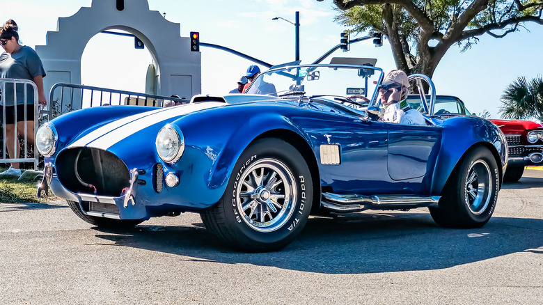 A blue 1965 Shelby Cobra at a car show