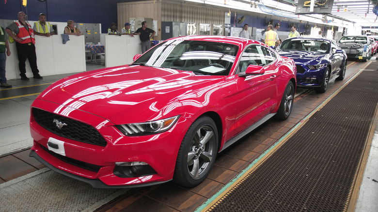 A red Ford Mustang on an assembly line