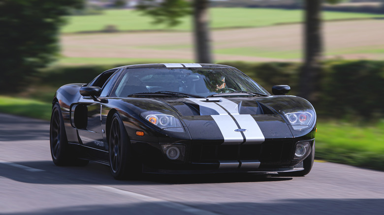 A black 2020 Ford GT driving down a country road