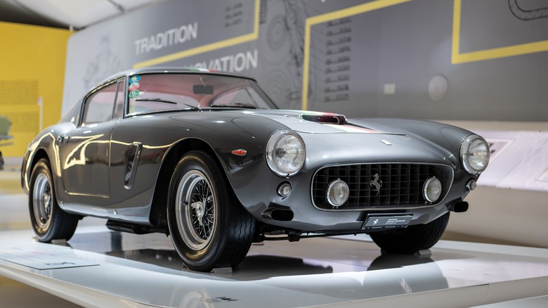 Grey Ferrari 250 GT SWB showcased at a museum