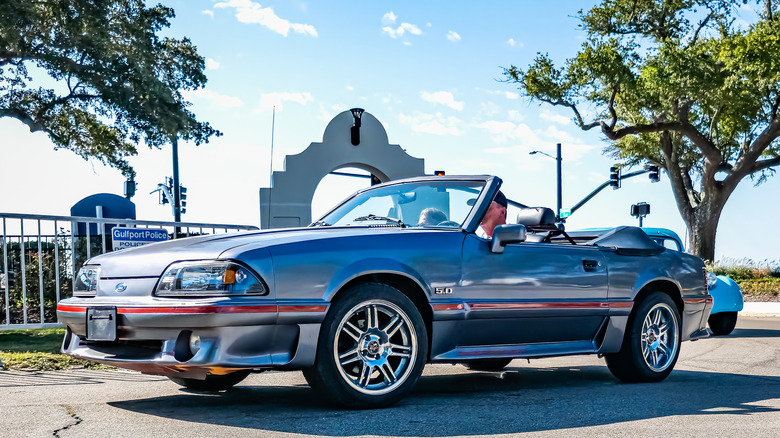 Low perspective front corner view of a 1988 Ford Mustang GT Convertible at a local car show