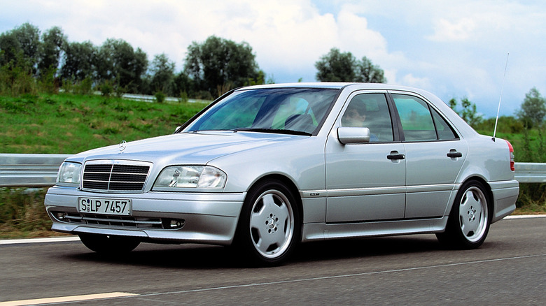 Silver Mercedes-Benz C36 AMG driving at speed